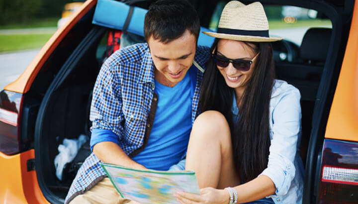 Couple reading map in car